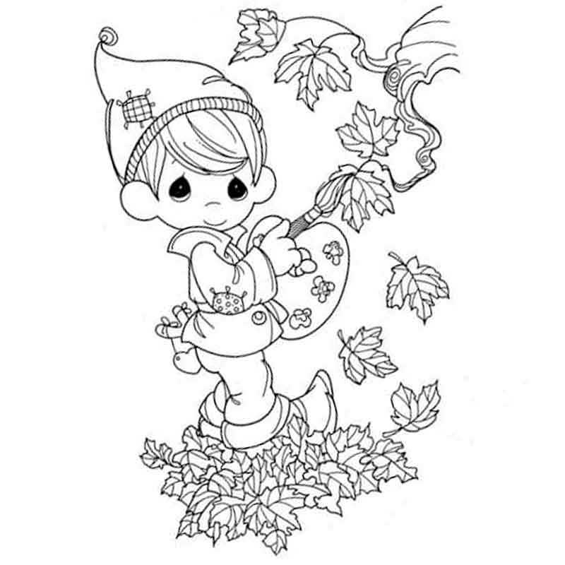мальчик раскрашивает осенние листья
